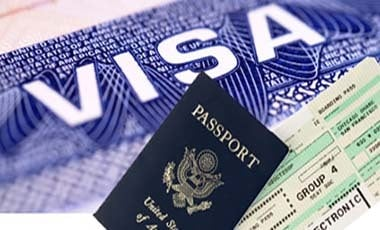 Close-up of passport with approved visa stamp